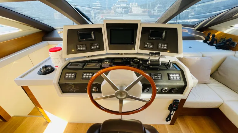  Yacht Photos Pics Helm of 2016 Canados 76 yacht with modern navigation controls and wooden steering wheel.