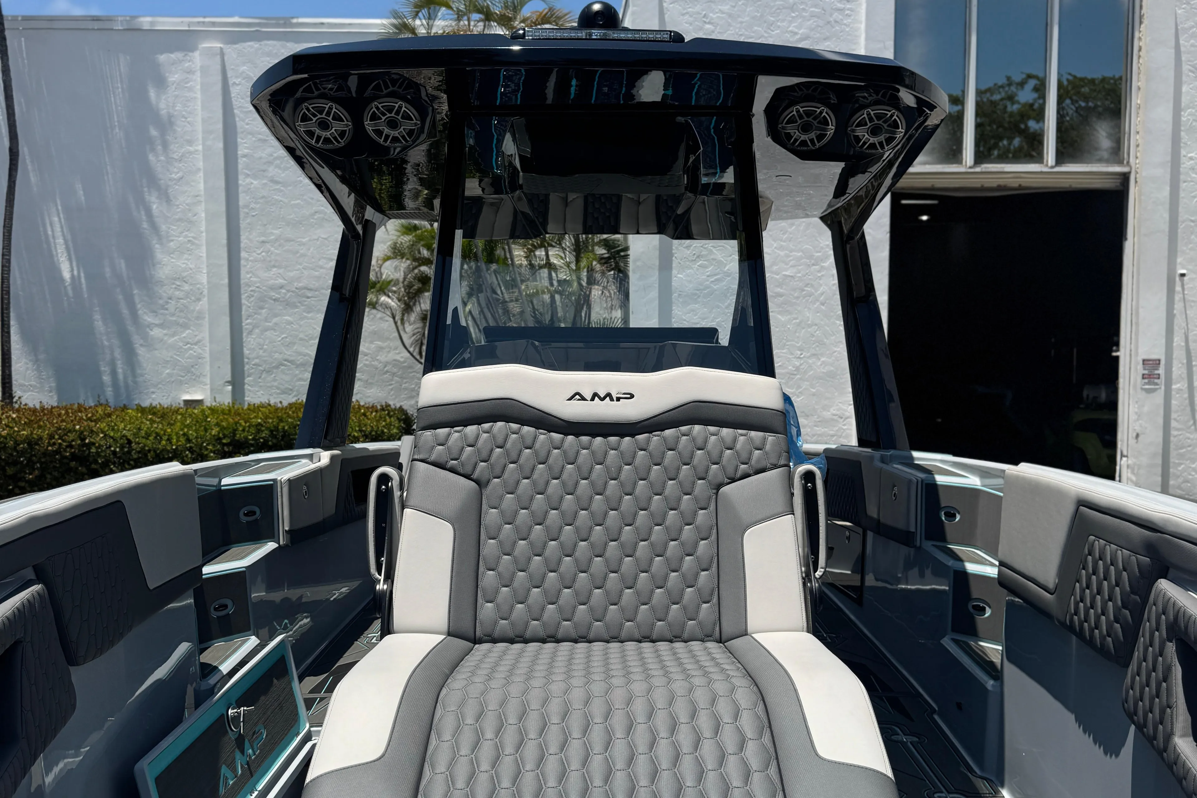 2024 AMP amp 333 boat with sleek design and modern seating, docked under clear blue sky.