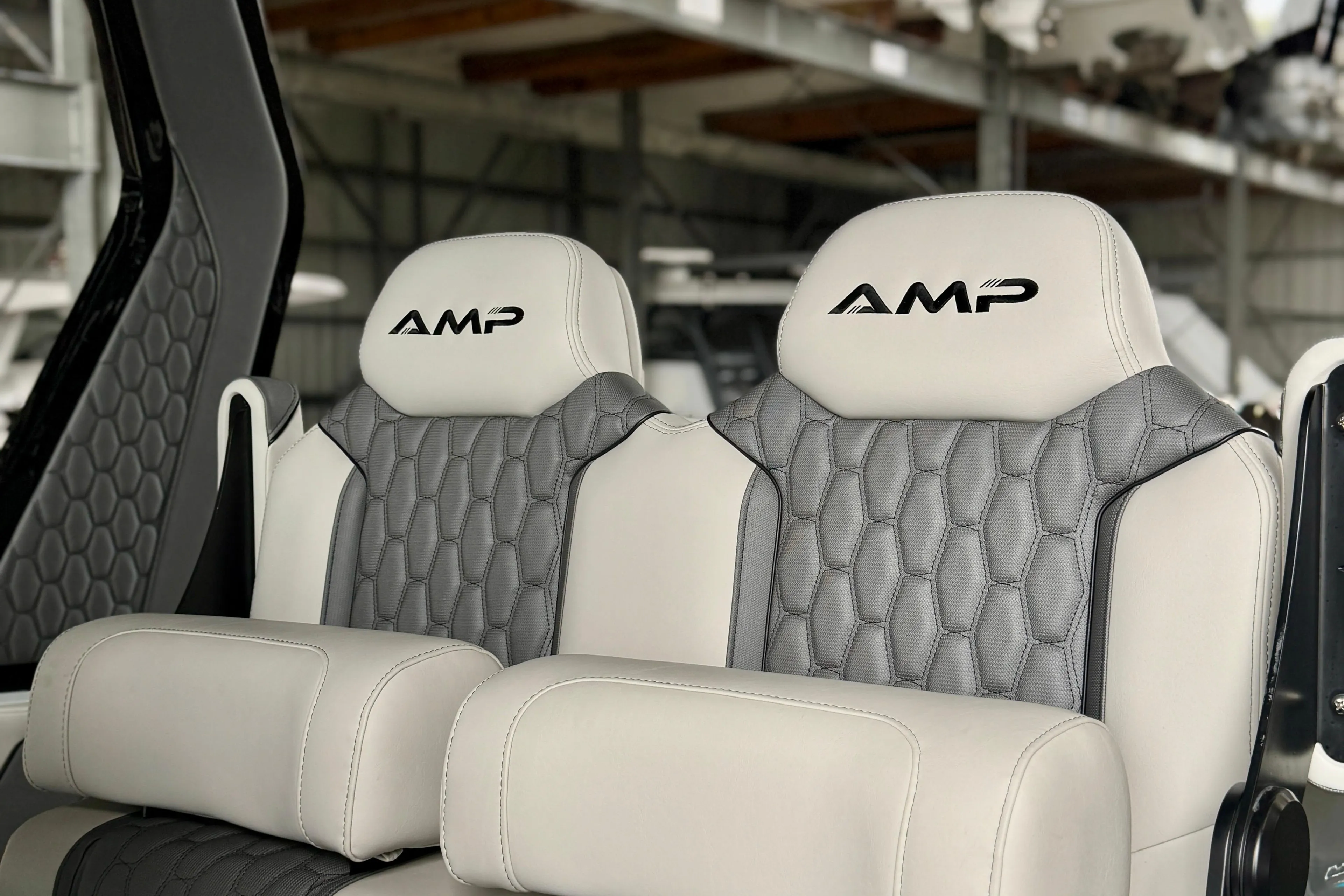 Luxurious AMP 333 boat seats, 2024 model, featuring elegant gray and white upholstery.