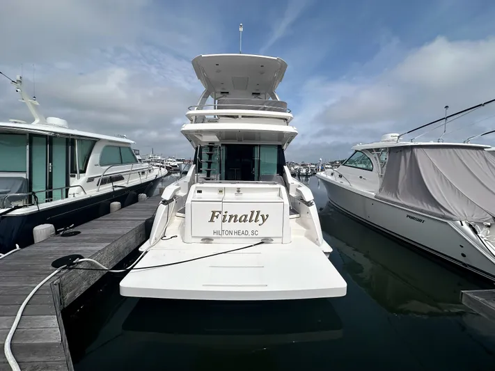 Finally Yacht Photos Pics 2021 Tiara Yachts F44 Flybridge docked at marina, rear view.