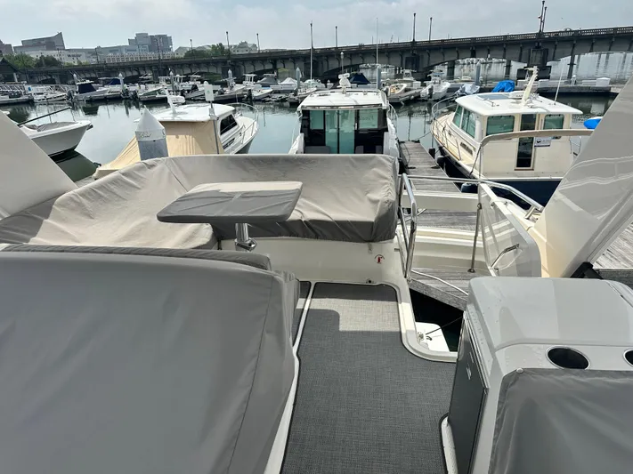 Finally Yacht Photos Pics 2021 Tiara Yachts F44 Flybridge docked at marina, showcasing covered seating area.