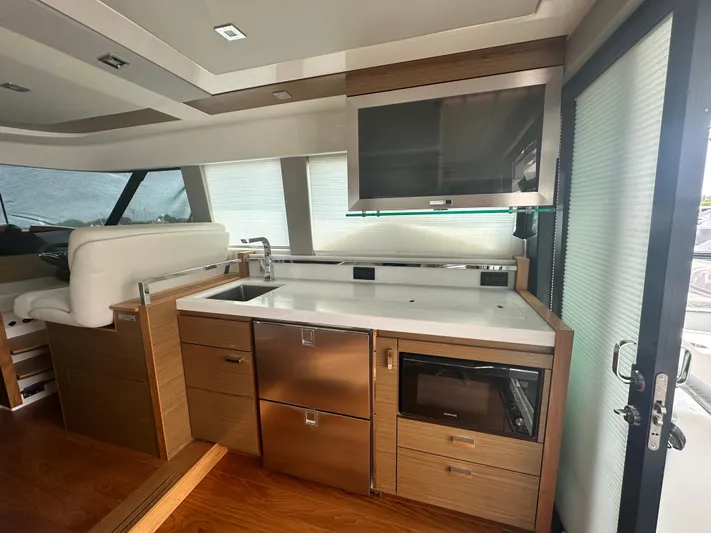 Finally Yacht Photos Pics Modern kitchen area in 2021 Tiara Yachts F44 Flybridge with sleek cabinetry and appliances.