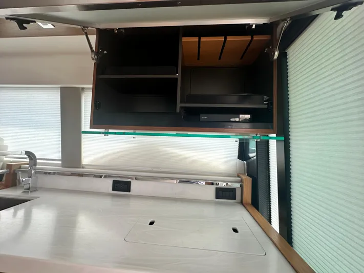 Finally Yacht Photos Pics Modern kitchen interior of 2021 Tiara Yachts F44 Flybridge with open cabinets.