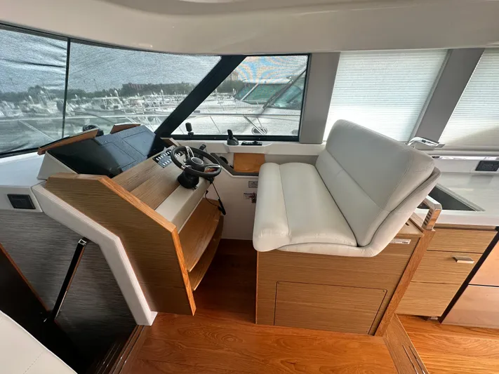 Finally Yacht Photos Pics 2021 Tiara Yachts F44 Flybridge helm with modern controls and comfortable seating.