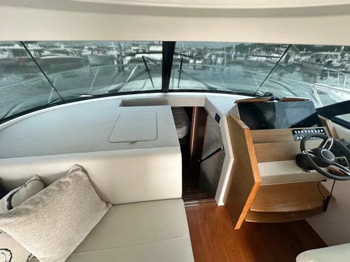 Finally Yacht Photos Pics 2021 Tiara Yachts F44 Flybridge interior with helm, seating, and panoramic windows.