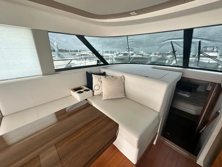 Finally Yacht Photos Pics Luxurious interior of 2021 Tiara Yachts F44 Flybridge with elegant seating and wooden table.