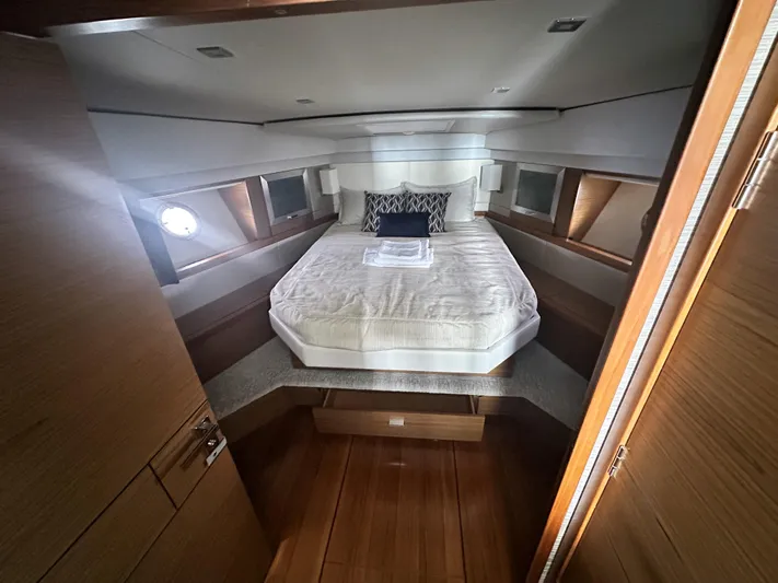Finally Yacht Photos Pics Luxurious bedroom in 2021 Tiara Yachts F44 Flybridge with elegant bedding and wood accents.