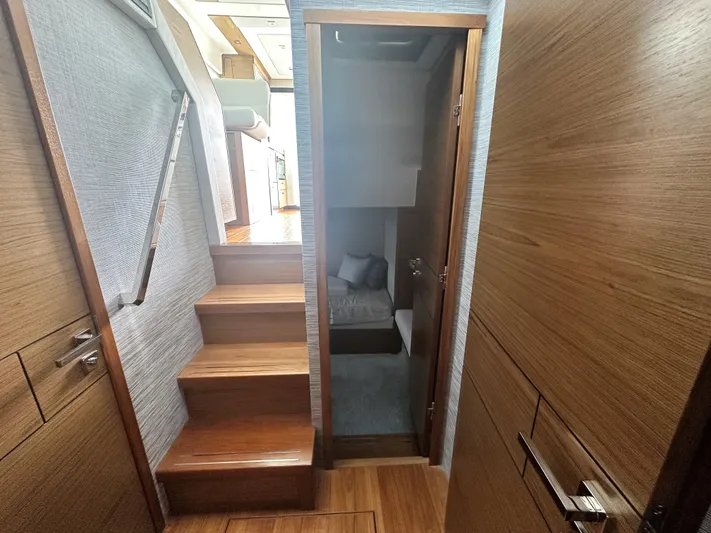 Finally Yacht Photos Pics Interior of 2021 Tiara Yachts F44 Flybridge, featuring wooden stairs and cozy cabin entrance.