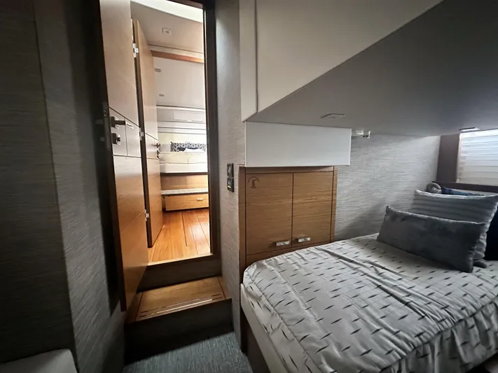 Finally Yacht Photos Pics 2021 Tiara Yachts F44 Flybridge cabin interior with bed and wooden accents.