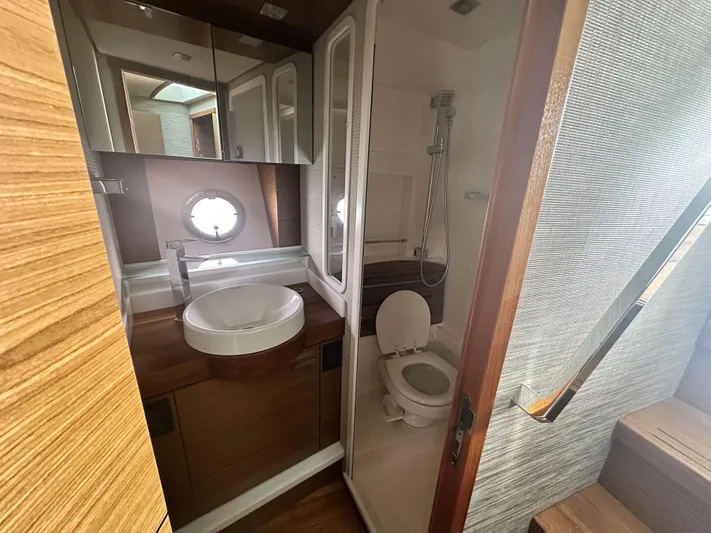 Finally Yacht Photos Pics Luxurious bathroom in 2021 Tiara Yachts F44 Flybridge with modern fixtures and wood accents.