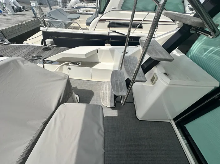 Finally Yacht Photos Pics 2021 Tiara Yachts F44 Flybridge deck with covered seating and stairs.