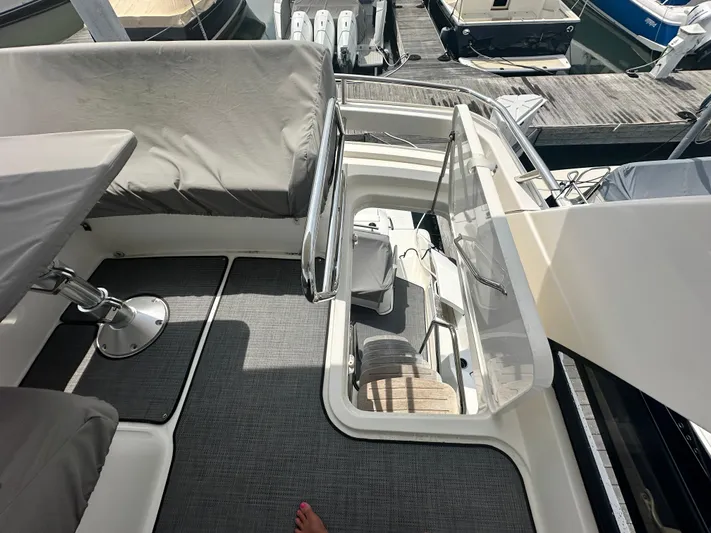 Finally Yacht Photos Pics 2021 Tiara Yachts F44 Flybridge interior with seating and access hatch, docked at marina.