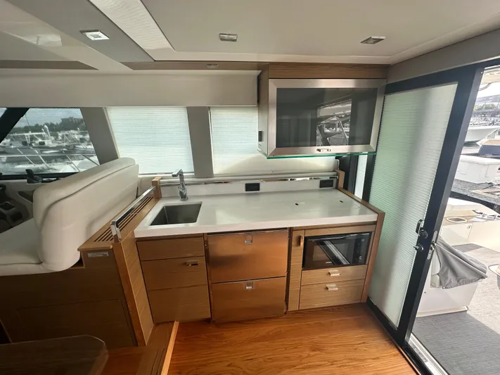 Finally Yacht Photos Pics Modern kitchen area in 2021 Tiara Yachts F44 Flybridge with sleek cabinetry and appliances.
