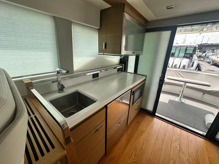 Finally Yacht Photos Pics Modern kitchen interior of 2021 Tiara Yachts F44 Flybridge with sleek countertops and appliances.