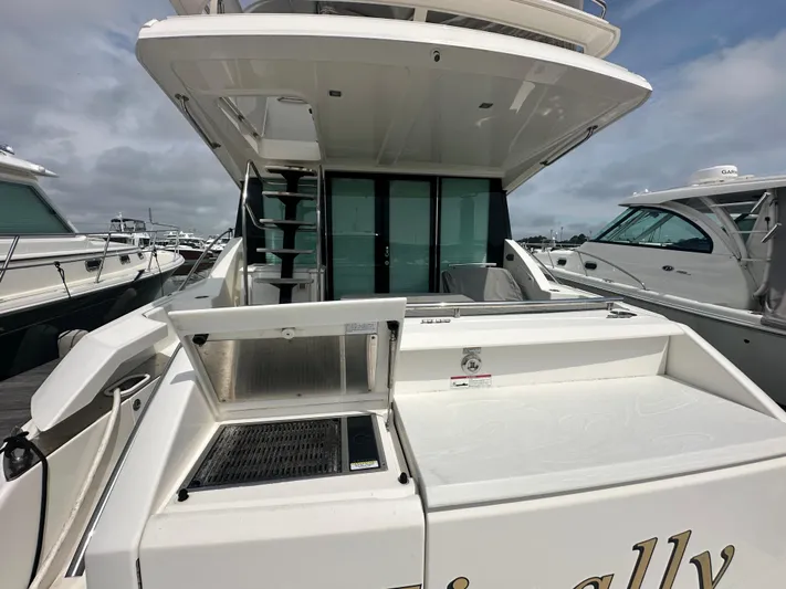 Finally Yacht Photos Pics 2021 Tiara Yachts F44 Flybridge, rear view with outdoor kitchen and seating area.