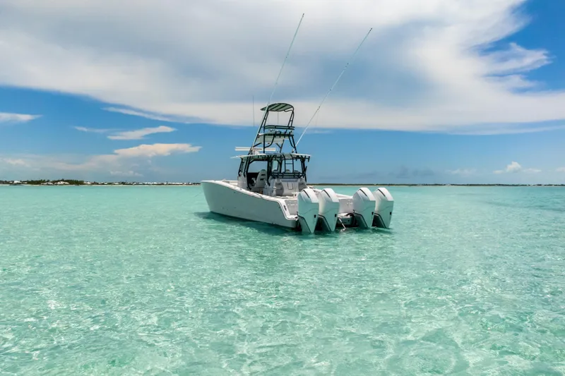 Reel Deal Yacht Photos Pics 2023 Freeman 42 LR boat on clear turquoise water under a blue sky.