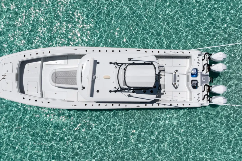 Reel Deal Yacht Photos Pics Aerial view of 2023 Freeman 42 LR boat on clear turquoise water.