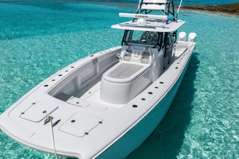 Reel Deal Yacht Photos Pics 2023 Freeman 42 LR boat on clear turquoise water, showcasing sleek design and advanced features.