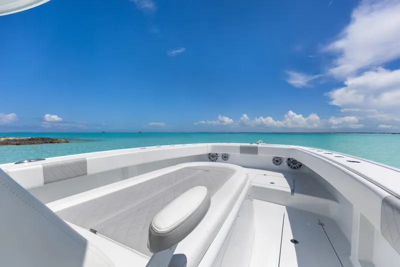 Reel Deal Yacht Photos Pics 2023 Freeman 42 LR boat on turquoise water under clear blue sky.
