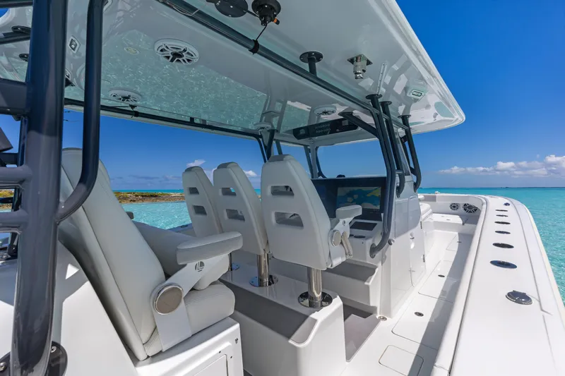 Reel Deal Yacht Photos Pics Interior view of 2023 Freeman 42 LR boat with luxurious seating and ocean backdrop.