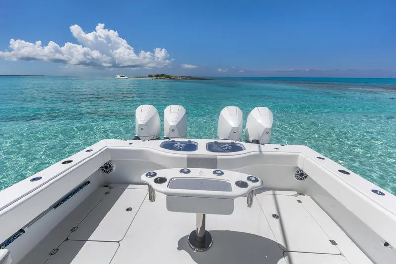 Reel Deal Yacht Photos Pics Freeman 42 LR boat, 2023 model, on clear turquoise water under a blue sky.