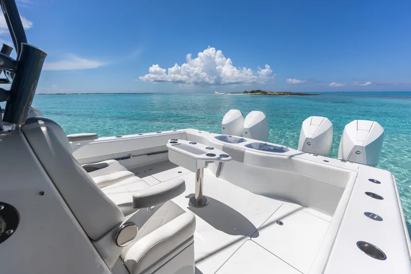 Reel Deal Yacht Photos Pics Luxury Freeman 42 LR boat, 2023 model, cruising in clear turquoise waters under a blue sky.