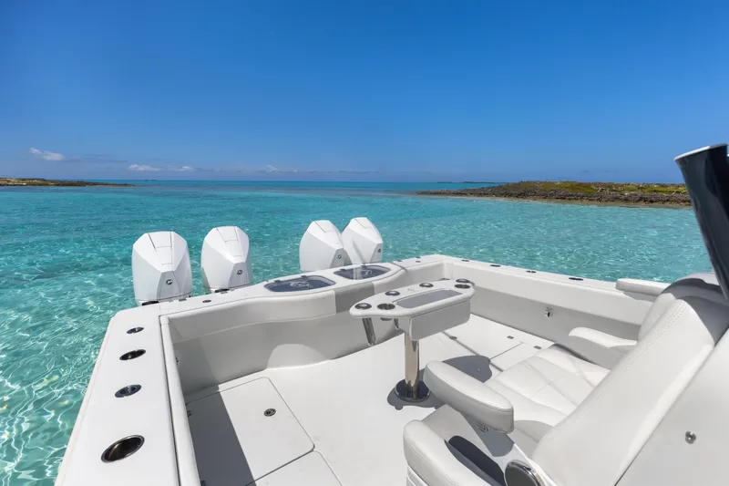 Reel Deal Yacht Photos Pics 2023 Freeman 42 LR boat on clear turquoise water, featuring four powerful engines.