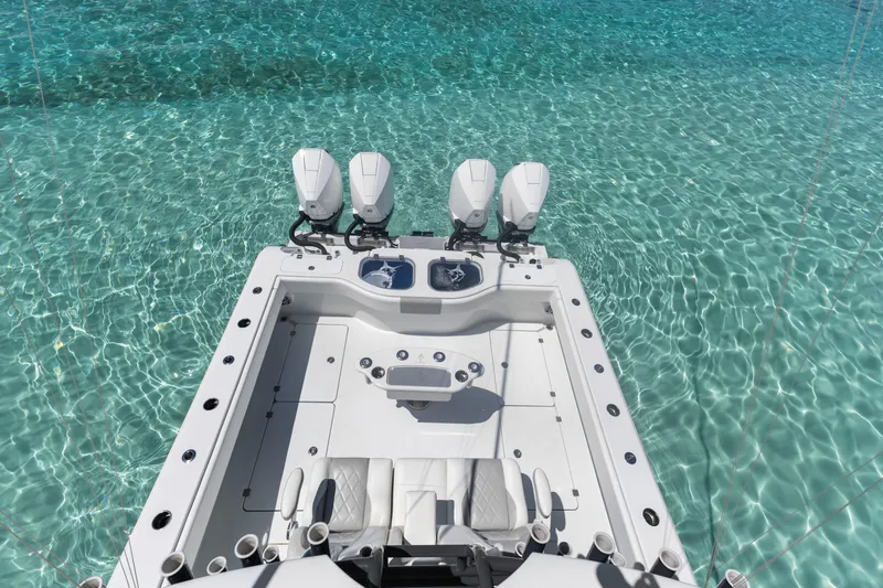 Reel Deal Yacht Photos Pics Freeman 42 LR 2023 boat on clear turquoise water, showcasing sleek design and powerful engines.