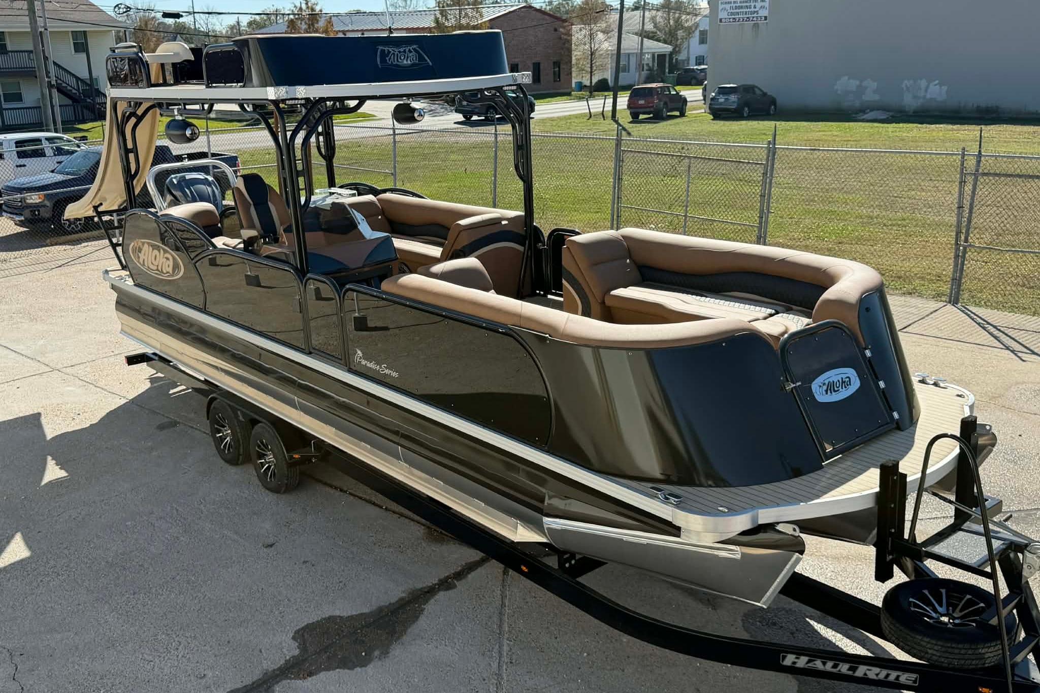 2026 Aloha Paradise 300 Sundeck pontoon boat on trailer, featuring luxurious seating.