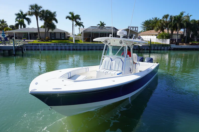 Knot Letting Go Yacht Photos Pics 2005 Regulator 32 boat on calm water with palm trees.