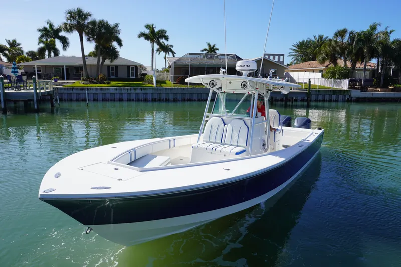 Knot Letting Go Yacht Photos Pics 2005 Regulator 32 boat with forward seating on calm water.
