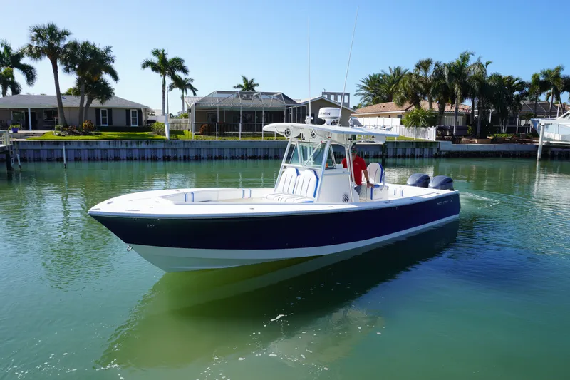 Knot Letting Go Yacht Photos Pics 2005 Regulator 32 Forward Seating boat on calm water.