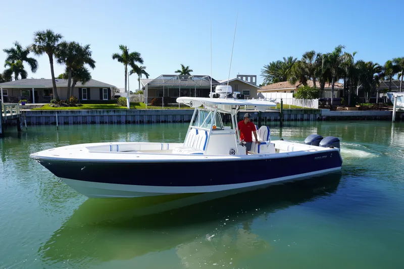 Knot Letting Go Yacht Photos Pics 2005 Regulator 32 Forward Seating boat on calm water.
