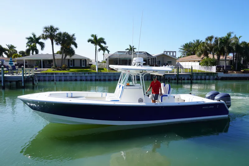 Knot Letting Go Yacht Photos Pics 2005 Regulator 32 boat on calm water with palm trees.