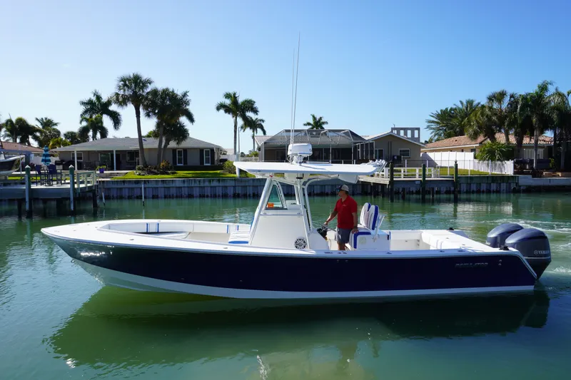 Knot Letting Go Yacht Photos Pics 2005 Regulator 32 boat on calm water with palm trees in background.