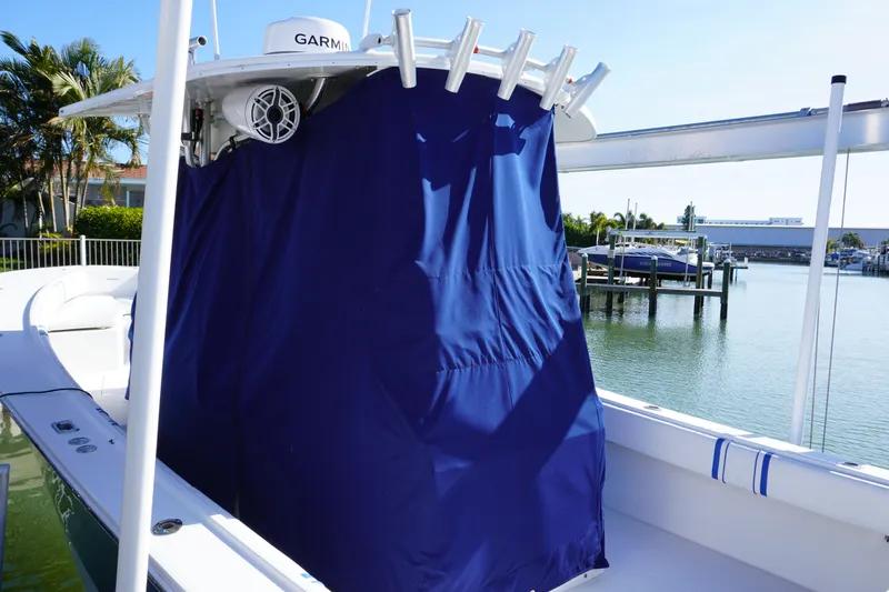 Knot Letting Go Yacht Photos Pics Regulator 32 boat with blue cover, 2005 model, docked by water.