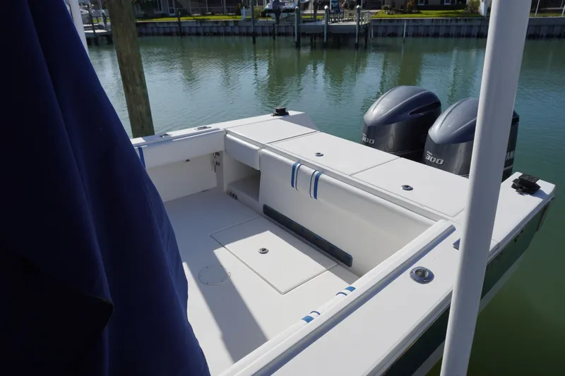 Knot Letting Go Yacht Photos Pics Regulator 32 boat with twin engines, calm water in the background.