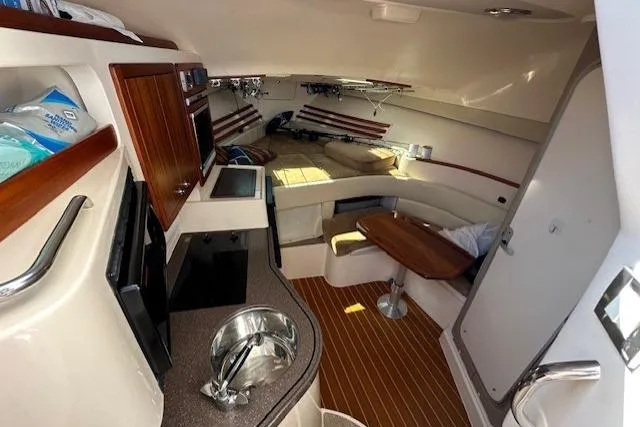  Yacht Photos Pics 2008 Grady-White Express 330 cabin interior with kitchenette and seating area.