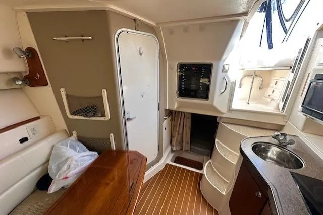  Yacht Photos Pics 2008 Grady-White Express 330 cabin interior with kitchenette and seating area.