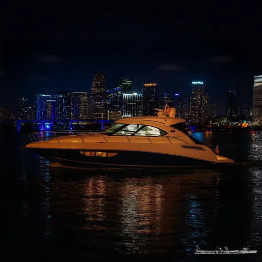 Moonwake Yacht Photos Pics 2014 Sea Ray 470 Sundancer yacht cruising at night with city skyline backdrop.