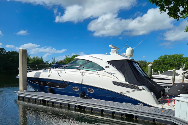 Moonwake Yacht Photos Pics 2014 Sea Ray 470 Sundancer yacht docked under a clear blue sky.