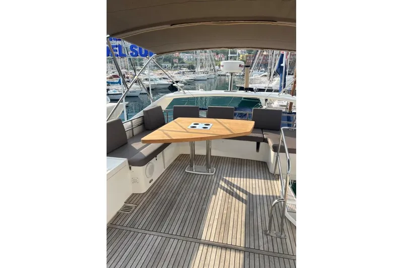 Lt Yacht Photos Pics Luxurious 2016 Prestige 550 yacht deck with seating and wooden table.