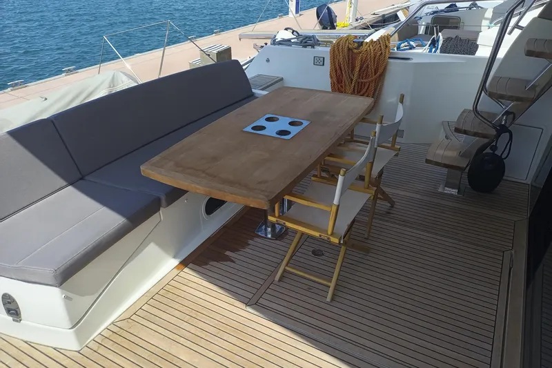 Lt Yacht Photos Pics Luxury deck seating on 2016 Prestige 550 yacht with wooden table and chairs.