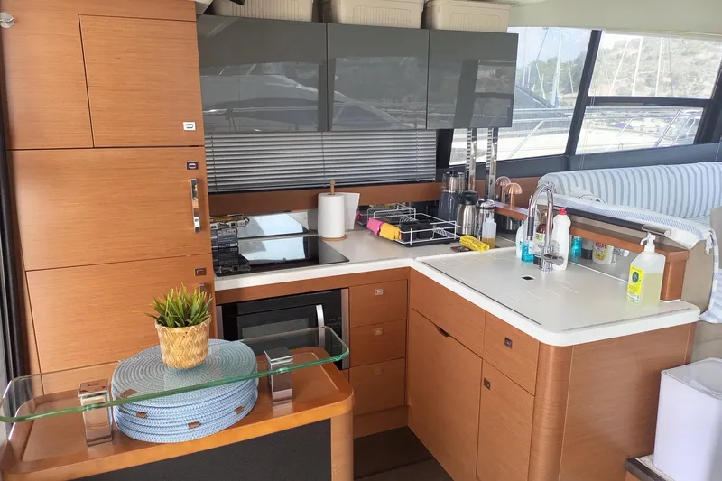 Lt Yacht Photos Pics Modern kitchen interior on a 2016 Prestige 550 yacht, featuring sleek cabinetry and appliances.