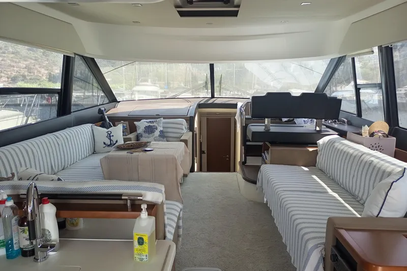 Lt Yacht Photos Pics Luxurious interior of a 2016 Prestige 550 yacht with striped seating and nautical decor.