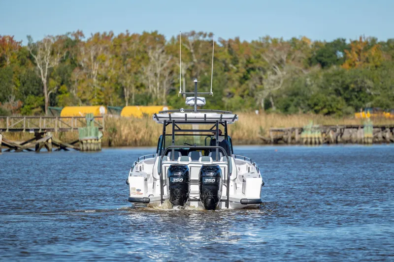  Yacht Photos Pics 2022 Axopar 37 Sun Top boat cruising on a calm river with scenic background.