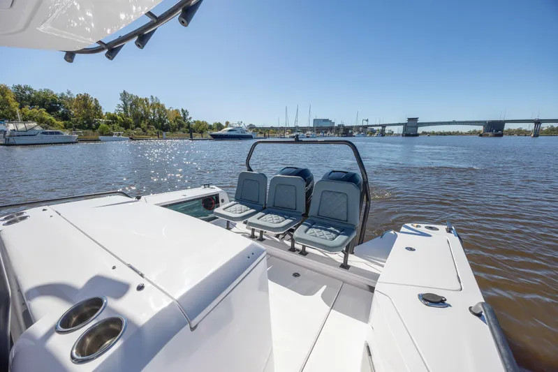  Yacht Photos Pics 2022 Axopar 37 Sun Top boat on a sunny day, featuring sleek seating and water view.