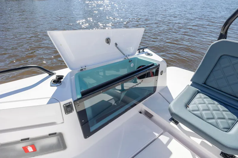  Yacht Photos Pics 2022 Axopar 37 Sun Top boat with open storage compartment and cushioned seating.