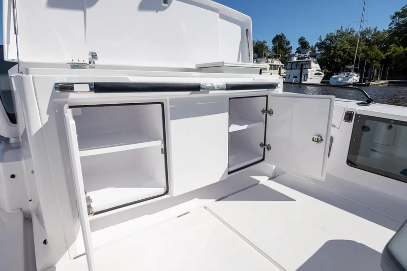  Yacht Photos Pics 2022 Axopar 37 Sun Top boat interior with open storage compartments.