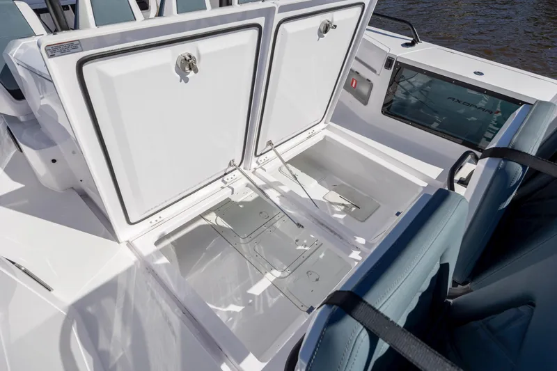  Yacht Photos Pics 2022 Axopar 37 Sun Top boat storage compartments open, showcasing spacious interior design.